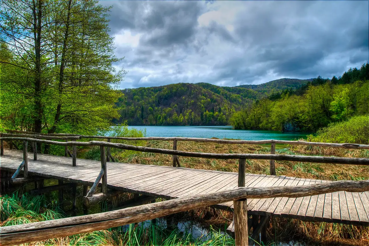 Visitors on the wooden boardwalk beside tufa cascades on a guided Croatia waterfall tour